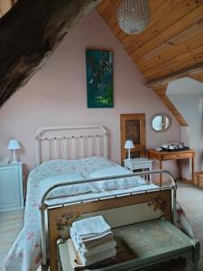 a bedroom with a bed in a attic at Chambre d'hôtes - Le jardin des Patissons in La Foret Du Parc