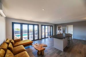 a living room with a couch and a table at Résidence Pierre & Vacances Premium Les Terrasses d'Arsella in Porto-Vecchio