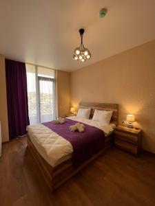 a bedroom with a large bed with two stuffed animals on it at Bessarion Boutique Hotel in Kutaisi +45 photos
