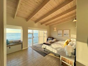 a bedroom with a bed and a view of the ocean at Waterfront Edge B5 in Swakopmund +38 photos