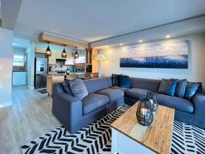 a living room with a couch and a table at Waterfront Edge B5 in Swakopmund