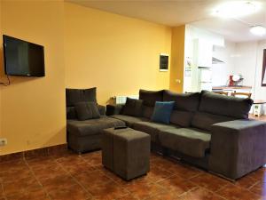 a living room with a couch and a flat screen tv at ARRASPINE in Astigarraga