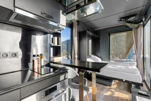 a kitchen with a dining table in a tiny house at Sogndal Fjordpanorama - Studio Cabins With View in Sogndal