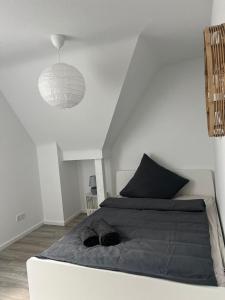 a bedroom with a large bed and a pendant light at Meerdesign - 8 Personen - zwischen Mannheim und Heidelberg in Ladenburg