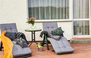 two chairs and a table in front of a window at Beautiful Home In Slowienkowo in Skrzeszewo