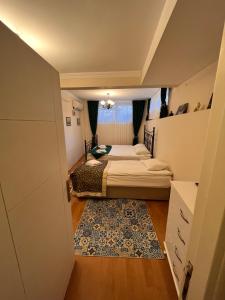a bedroom with two beds and a rug at Stone Garden Apart in Istanbul