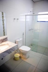 a bathroom with a shower and a toilet and a sink at Regional Plaza Hotel Event Park in Jales