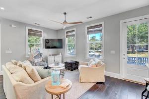 a living room with a couch and chairs and windows at The Darby House in Charleston +8 photos