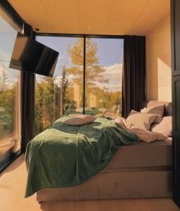 a bedroom with a bed with a large window at Juniper Villas I 