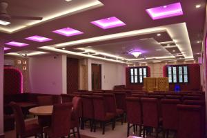 a room with chairs and tables and purple lights at HOTEL KAILASH in Deoria