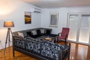 a living room with a couch and a table at Apartman Petar Pan in Grude