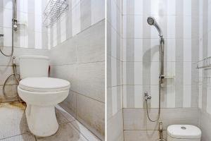 a bathroom with a toilet and a shower at OYO 91795 Kos Jeehel Syariah in Sidoarjo