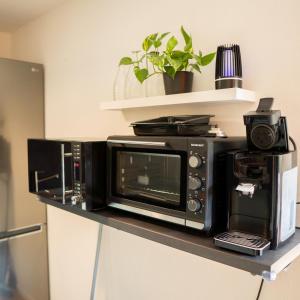 a microwave sitting on top of a kitchen counter at MOREHOME-Apartments in Mindelheim
