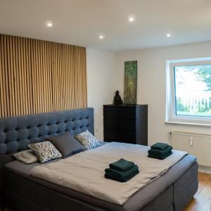 a bedroom with a large bed with green pillows on it at MOREHOME-Apartments in Mindelheim