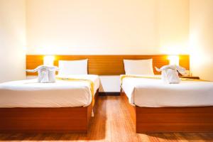 Postel nebo postele na pokoji v ubytování Neptuna Hotel