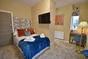 a bedroom with a bed with towels on it at Moat House in Rawtenstall