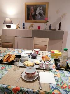 a table with a plate of food on it at Chambre et table d'hôtes La Meule in Poligny