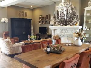 a dining room with a table and a fireplace at B&B Le Jardin in Pelt