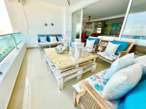 a living room with a couch and a table at 3 Bedrooms At Marbella Beachfront Juan Dolio in Juan Dolio