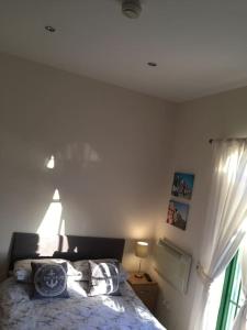 a bedroom with a bed and a window at converted chapel filey floor to ceiling arch window in Filey