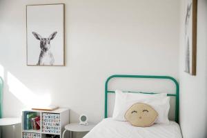 a bedroom with a bed and a picture of a goat at The Nebraska Retreat in Dennes Point