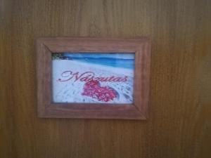 a picture in a wooden frame on a wall at Total Relax Apartmanház in Bogács