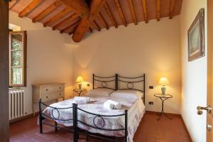 a bedroom with a bed and two lamps and a window at Live Tuscany! Apartment on the hills of Florence! in Ginestra