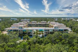 an aerial view of a building with trees at MISTIQ Tulum Luxury Apartments in Tulum
