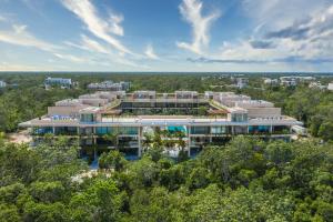 an aerial view of a building with trees at Mistiq Tulum in Tulum