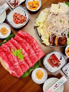a wooden table with plates of food on it at 旅館 竹屋 Takeya in Yufuin