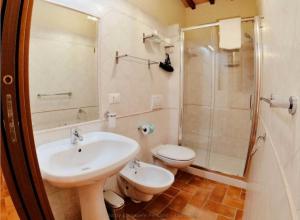 a bathroom with a sink and a toilet and a shower at La Casetta di Lola in Norcia