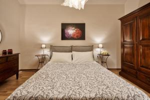 a bedroom with a large bed and a dresser at Casa LENA by Apartments To Art in Turin