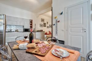 a table with wine glasses and food on it at Casa LENA by Apartments To Art in Turin