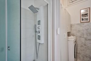a shower with a glass door in a bathroom at Casa LENA by Apartments To Art in Turin