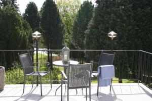 a table and four chairs on a patio at Home Hotel Park in Halden