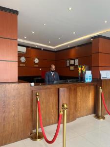 a man sitting at a bar in a courtroom at Al Muhaidb Al Taif Hotel in Al Hada