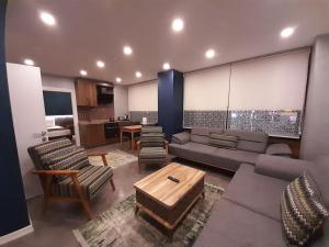 a living room with a couch and chairs and a table at Rhisos Gold Otel in Rize