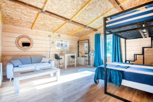 a bedroom with a bed and a desk in a room at Villa de 2 chambres avec piscine privee jardin clos et wifi a Sapogne et Feucheres in Sapogne-et-Feuchères