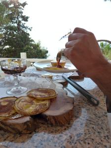 a person eating a plate of food on a table at Yasos By The Sea in Çeşme