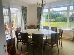 a dining room with a table and chairs at La Mer in Ferring