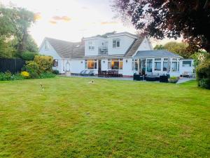 a white house with a yard in front of it at La Mer in Ferring