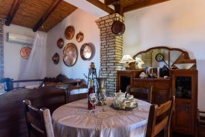 une salle à manger avec une table, des chaises et une cheminée dans l'établissement Eros Pittoresque Retreats - Perfect location, Panoramic Seaview, à Koroni