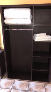 a black cabinet with white towels on top of it at hôtel MISTRAL in Oran