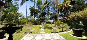 a garden with white vases on the grass at Sun Kiss lagoon bentota in Bentota