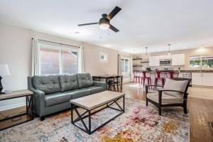 a living room with a couch and a table at The Wendover - Entire Home near Lake Michigan! in Norton Shores