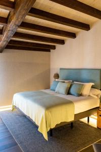 a bedroom with a large bed with a blue headboard at Casa Rural San Andrés de Teixido in Cedeira