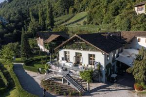 an aerial view of a house in the mountains at Ferienapartments Gutshof Brandis in Lana