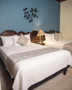 Кровать или кровати в номере Hotel Plaza Copan