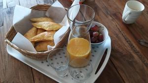 a tray with a basket of bread and a basket of fruit at Appartement Mijn Ouders Bed en Breakfast Emmeloord in Emmeloord