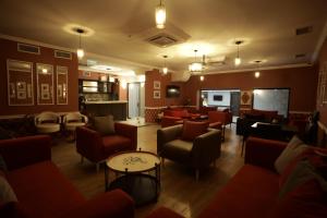 a lobby with couches and chairs and a bar at Redline Hotel in Tbilisi City